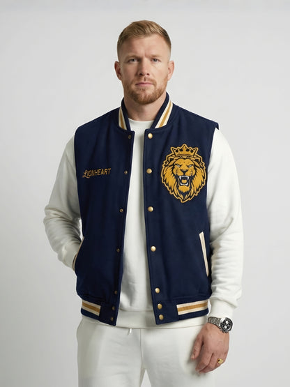 Man wearing a navy blue letterman jacket with a lion emblem on a white background