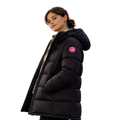 Woman wearing a black puffer jacket with a brand logo on a white background