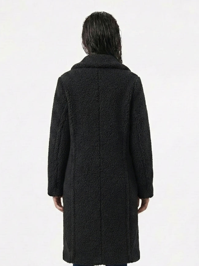 Person wearing a black coat from behind on a white background
