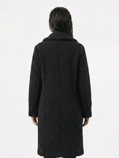 Person wearing a black coat from behind on a white background