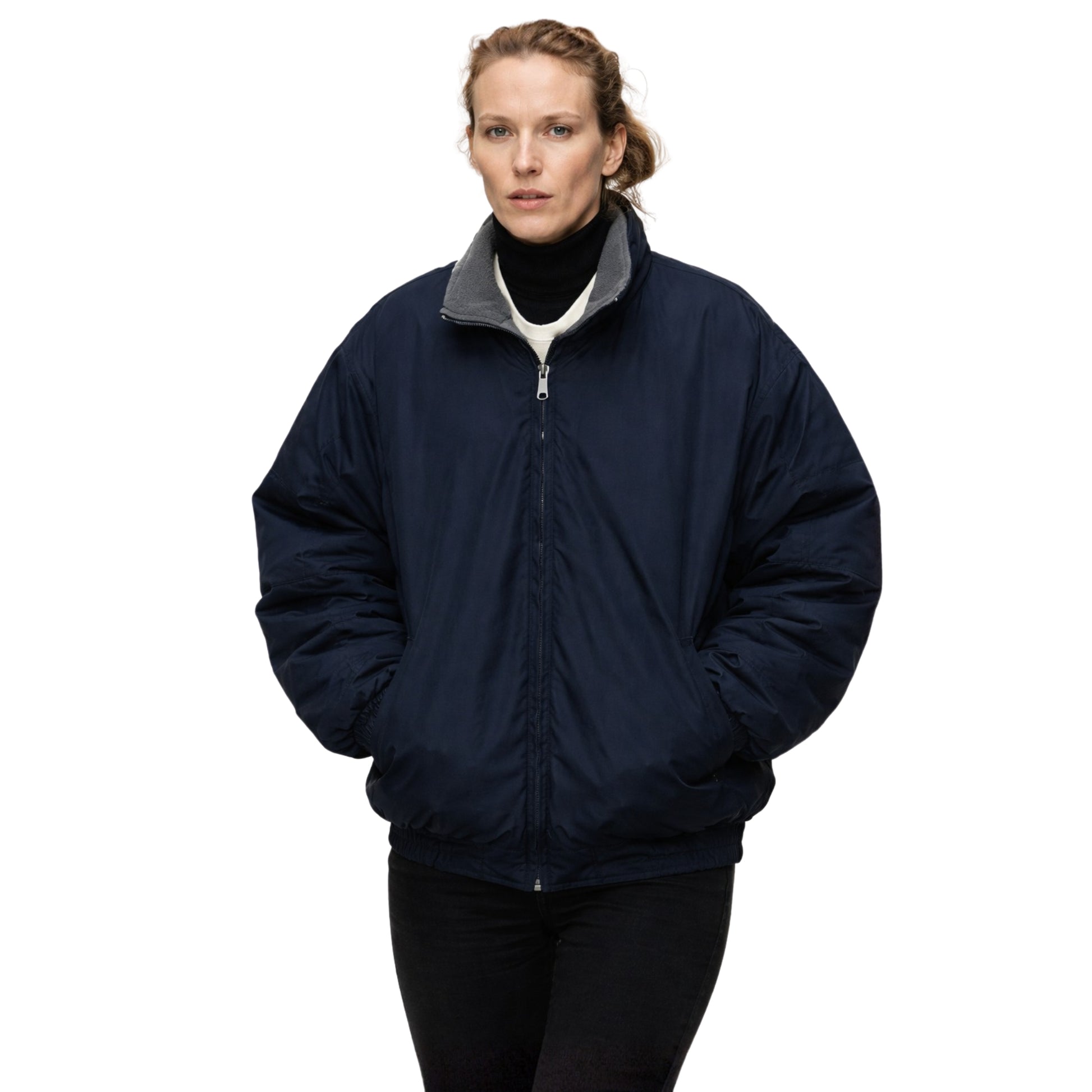 Person wearing a navy blue jacket with a white background