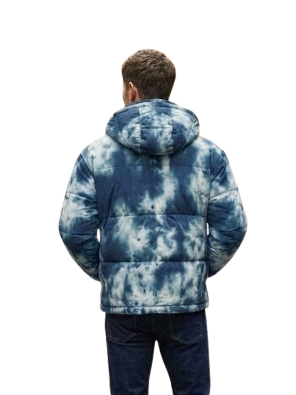Person wearing a blue tie-dye puffer jacket on a white background