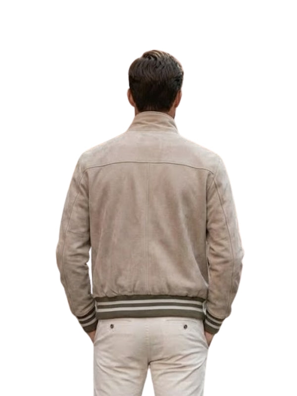 Man wearing a beige jacket with striped cuffs on a white background