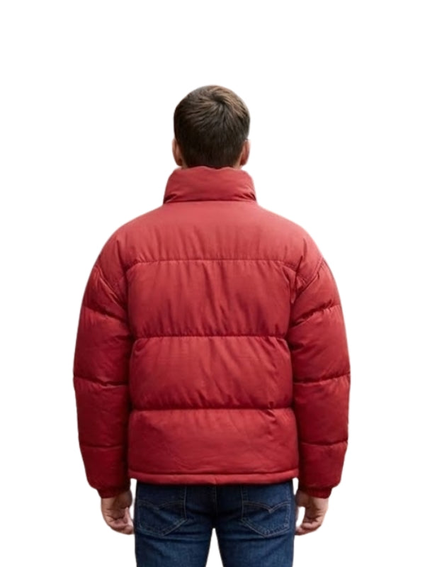 Person wearing a red puffer jacket on a white background
