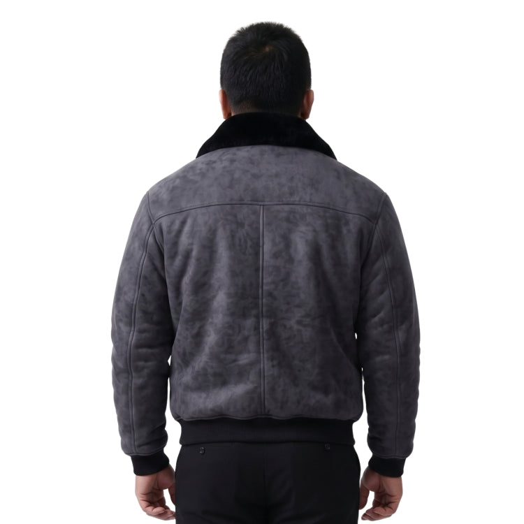 person wearing black jacket standing in front of a white background 