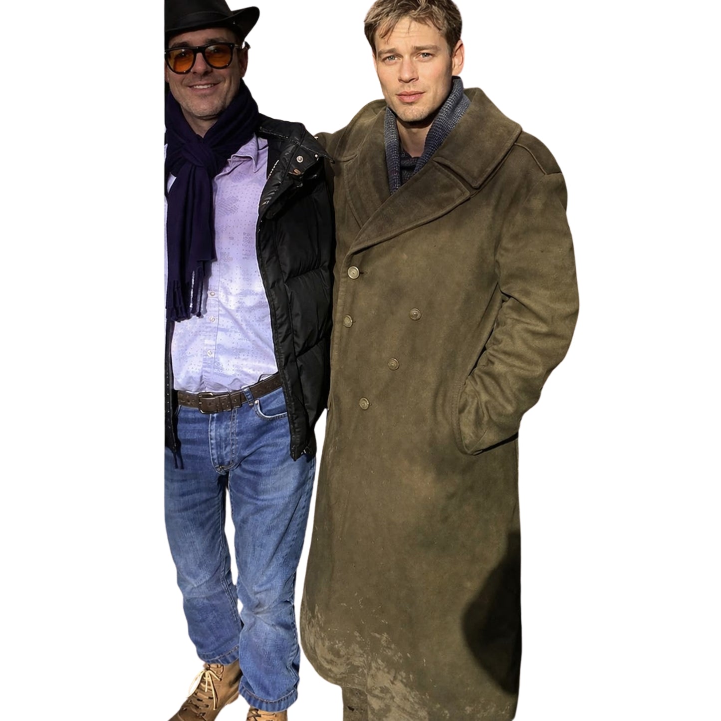 Two men, one wearing a black coat and sunglasses, the other in a long brown coat, on a white background.