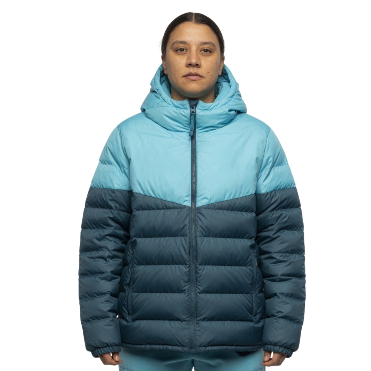 Person wearing a two-tone blue and navy puffer jacket on a white background