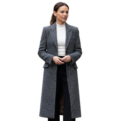 Woman wearing a long gray coat on a white background