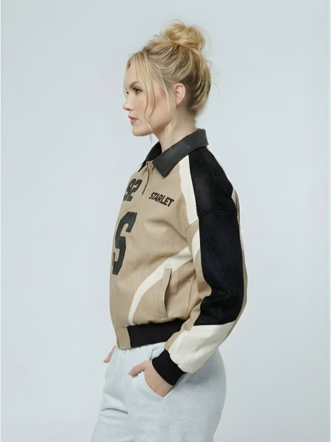 Woman wearing a beige and black varsity jacket with 'Starlet' branding on a light gray background