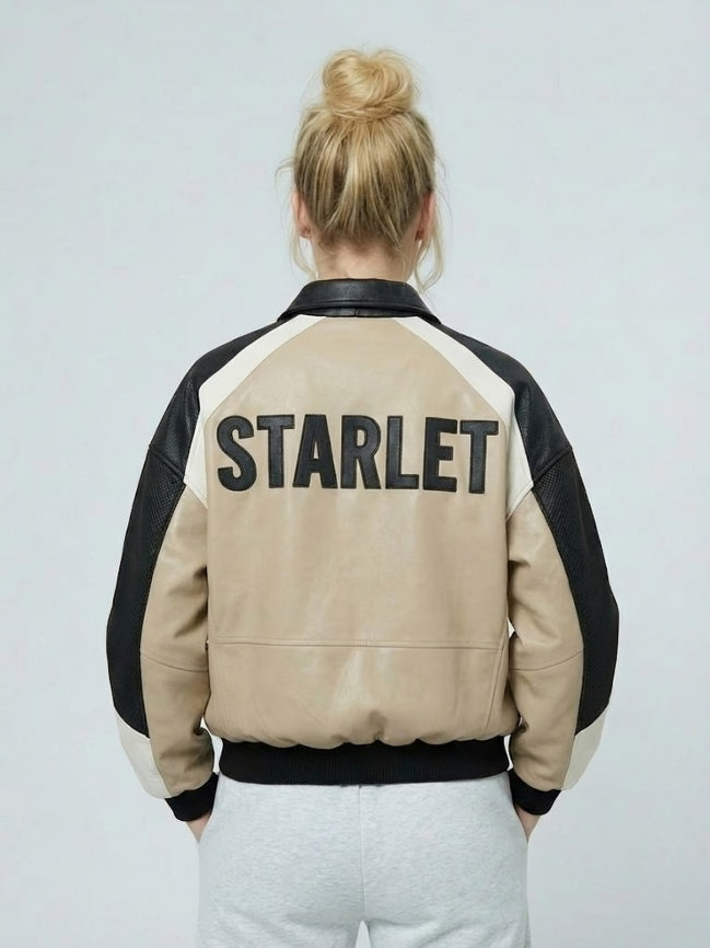 Person wearing a beige and black jacket with 'STARLET' text on a plain background