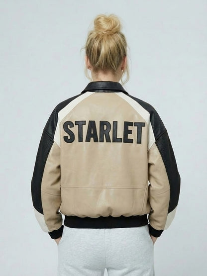 Person wearing a beige and black jacket with 'STARLET' text on a plain background