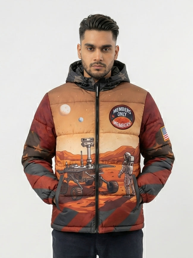 Man wearing a space-themed jacket with patches and graphics on a plain background