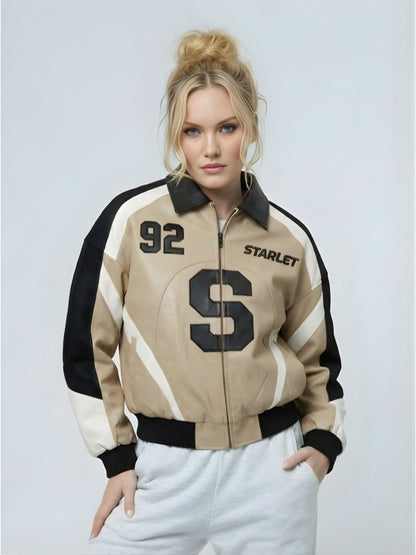 Woman wearing a beige and black jacket with '92' and 'STARLET' text on a light gray background