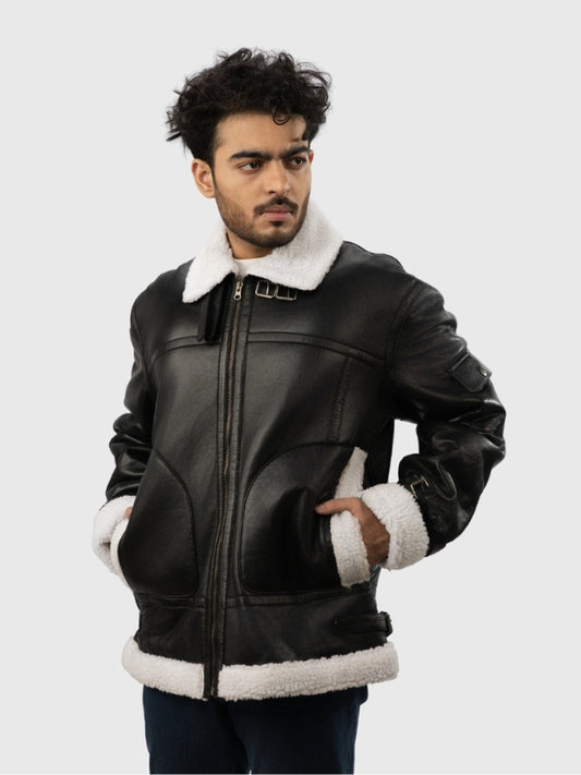 Man wearing a black leather jacket with white fur trim on a light gray background