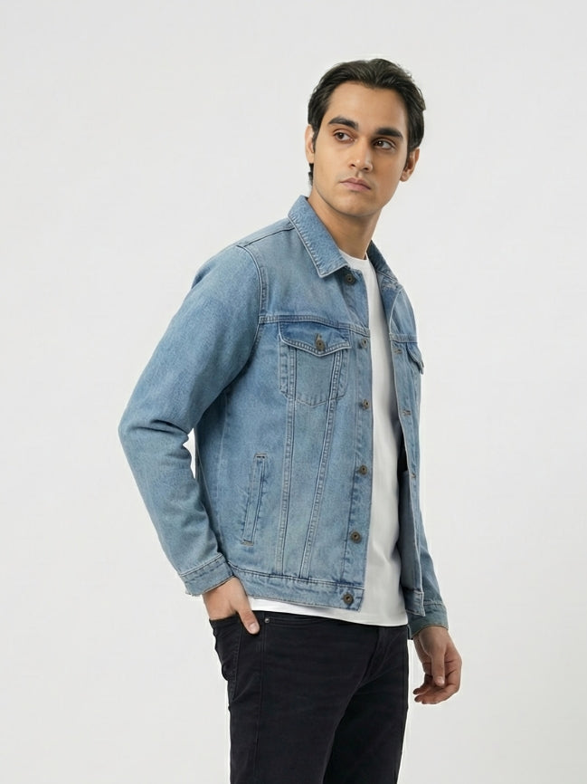 Man wearing a light blue denim jacket on a white background