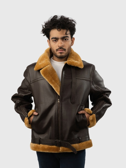 Man wearing a brown leather jacket with fur trim on a white background