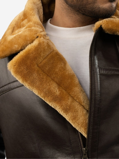 Close-up of a brown shearling jacket with a white shirt underneath.
