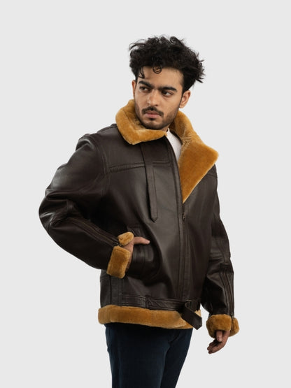 Man wearing a brown leather jacket with fur trim on a white background