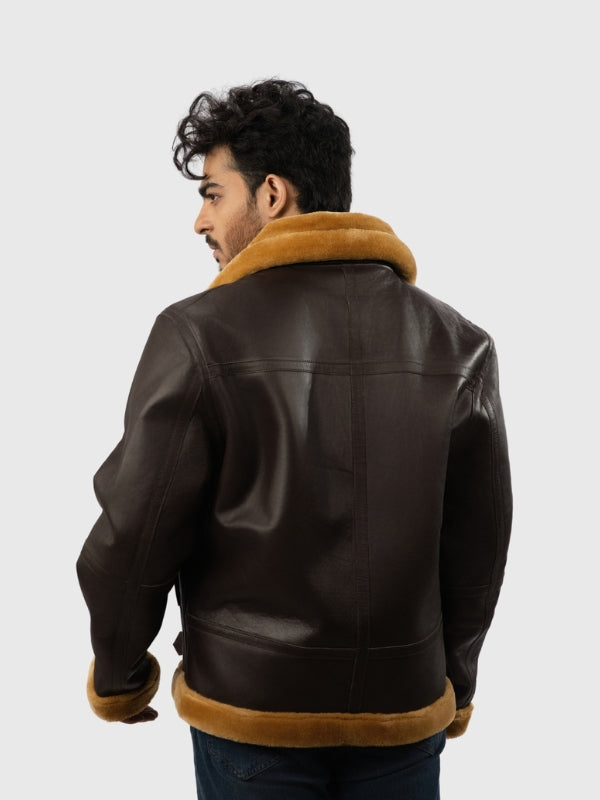 Man wearing a brown leather jacket with fur trim on a white background