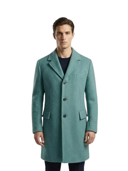 Man wearing a teal overcoat on a white background