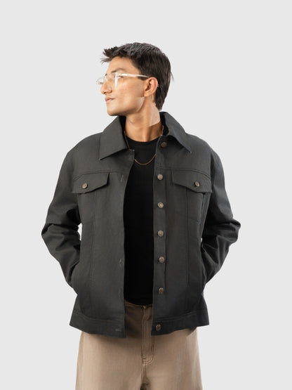 Man wearing a dark gray jacket on a light gray background