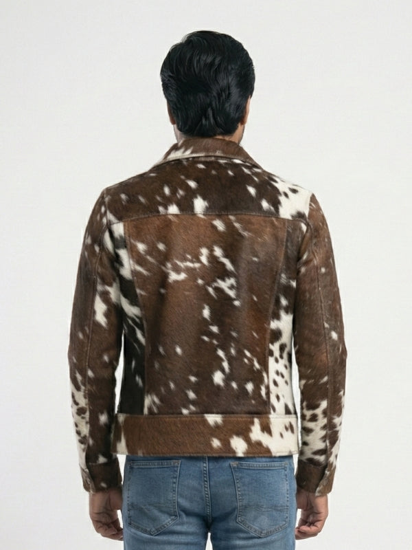 Person wearing a brown and white spotted jacket on a plain background