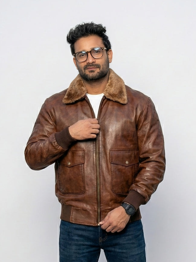 Man wearing a brown leather jacket with fur collar on a white background