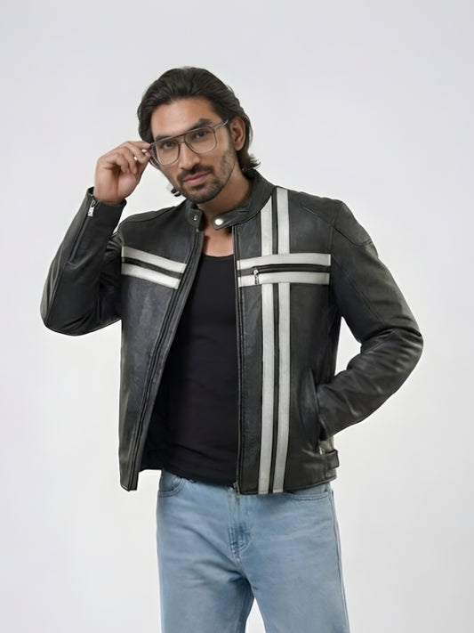 Man wearing a black leather jacket with white stripes, black shirt, and light blue jeans on a white background