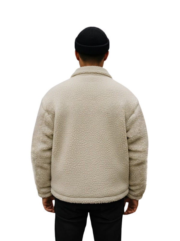 Person wearing a beige fleece jacket on a white background