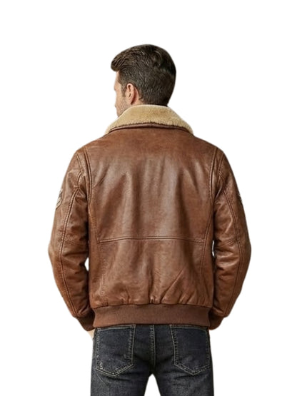 Man wearing a brown leather jacket with a shearling collar on a white background