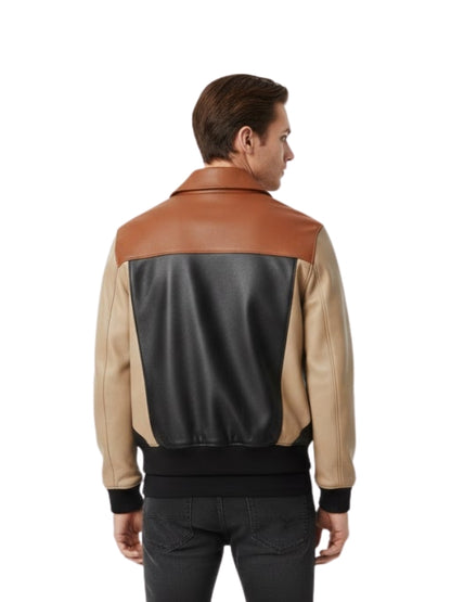 Man wearing a two-tone leather jacket with brown and beige sections on a white background