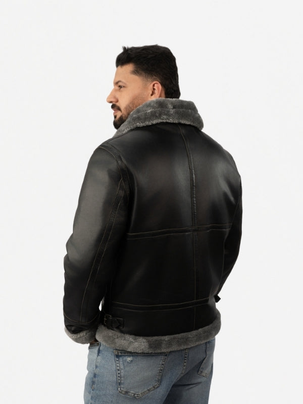 Man wearing a black leather jacket with gray fur lining on a white background