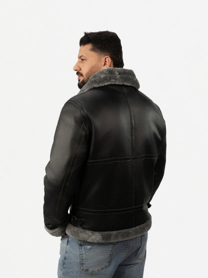 Man wearing a black leather jacket with gray fur lining on a white background