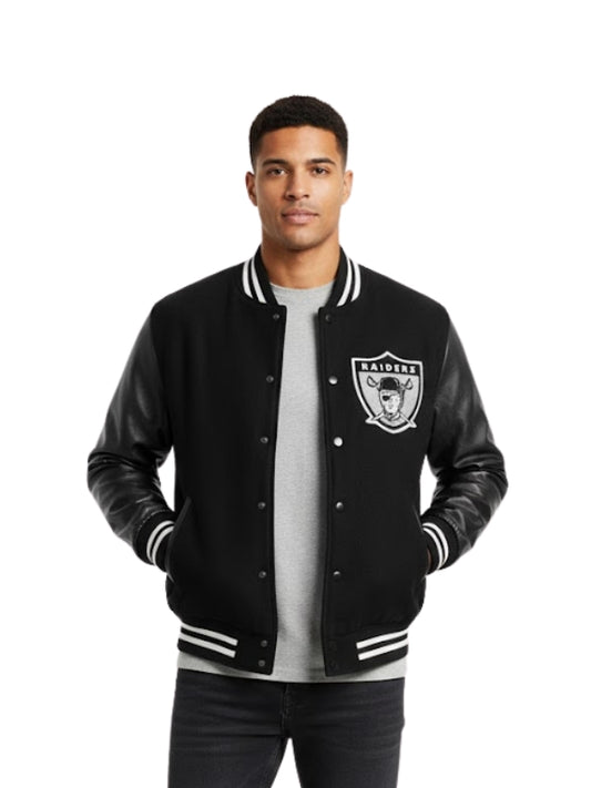 Man wearing a black varsity jacket with a logo on a white background