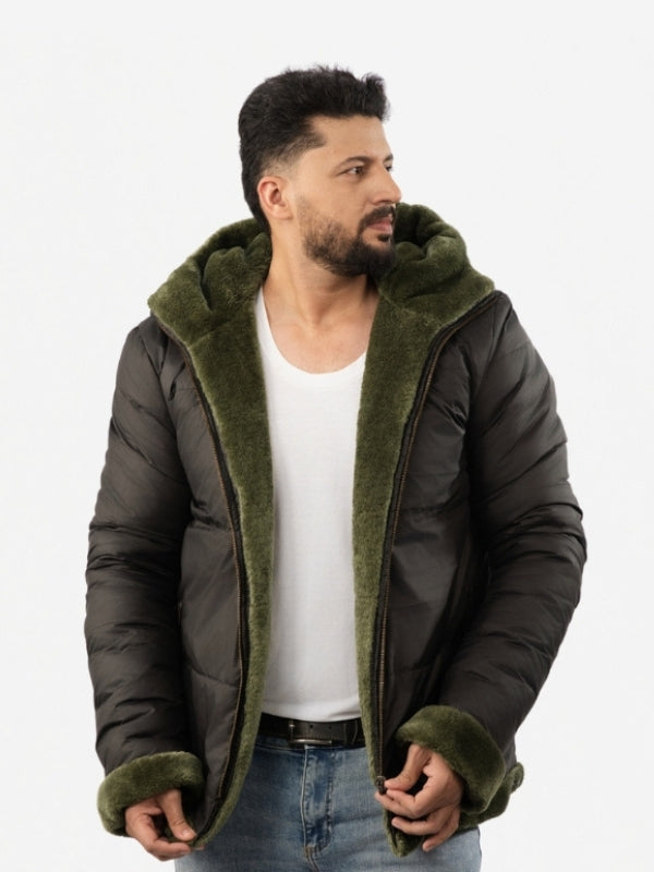 Man wearing a dark green puffer jacket with olive green hood and cuffs on a white background