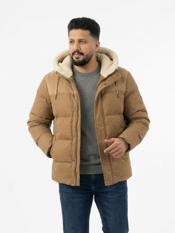 Man wearing a brown puffer jacket with a white hood on a white background