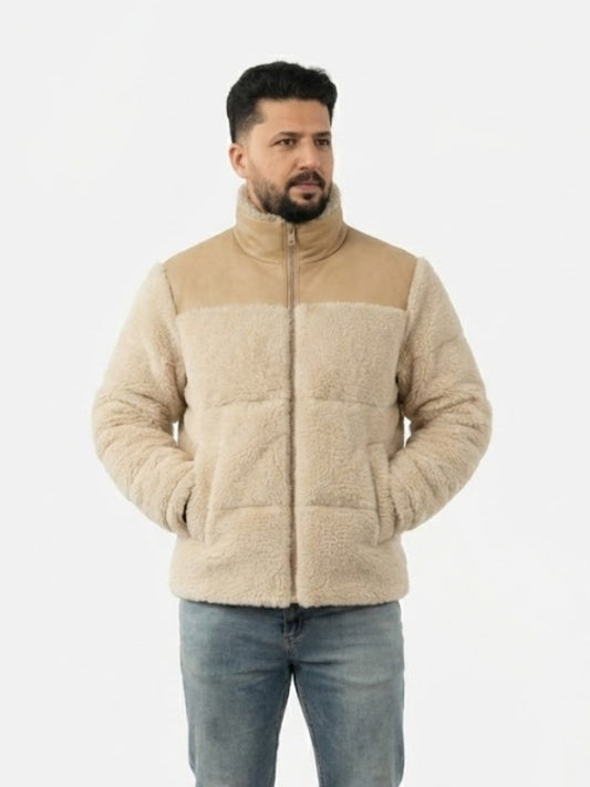 Man wearing a beige quilted jacket on a white background