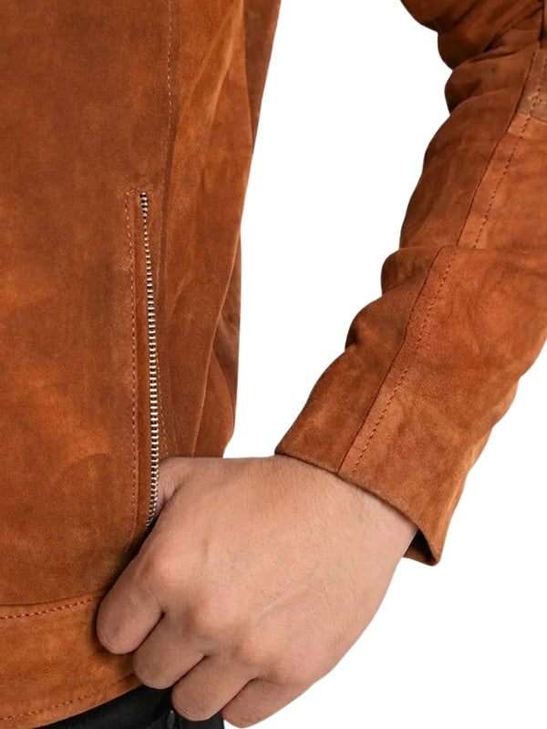 Close-up of a brown suede jacket with a hand holding a handle.