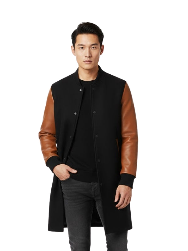 Man wearing a black coat with brown leather sleeves on a white background