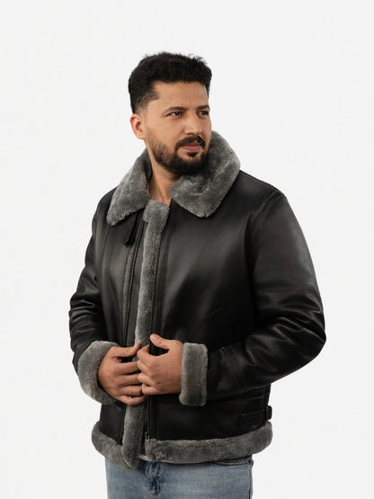 Man wearing a black leather jacket with gray fur lining on a white background