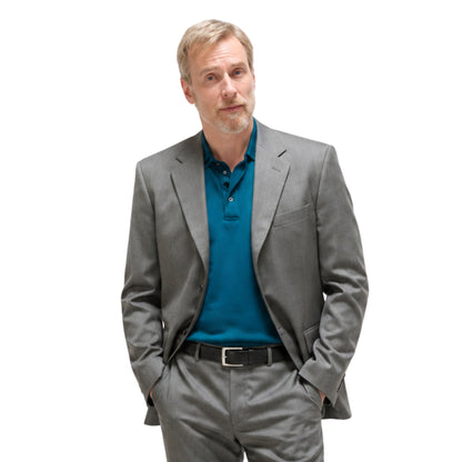 Man wearing a gray suit and blue shirt on a white background