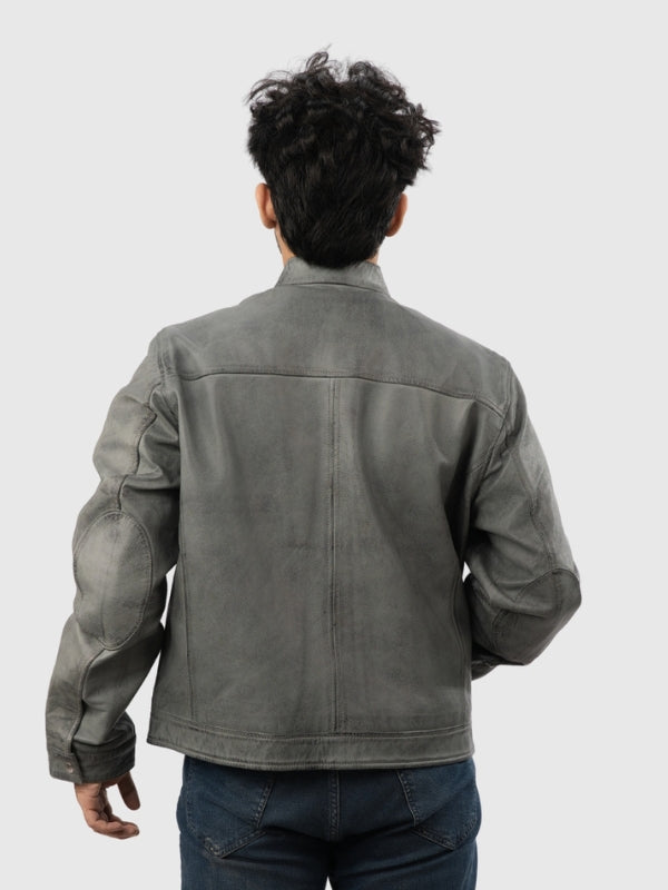 Person wearing a gray leather jacket on a white background