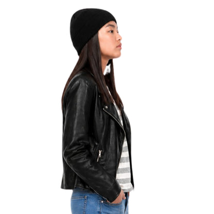 Person wearing a black leather jacket, black beanie, and striped shirt on a white background