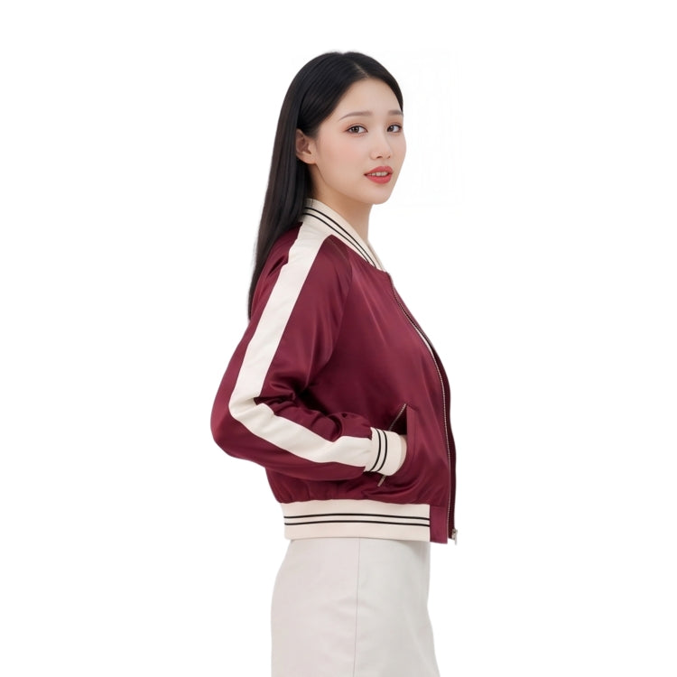 Woman wearing a maroon jacket with white accents on a white background