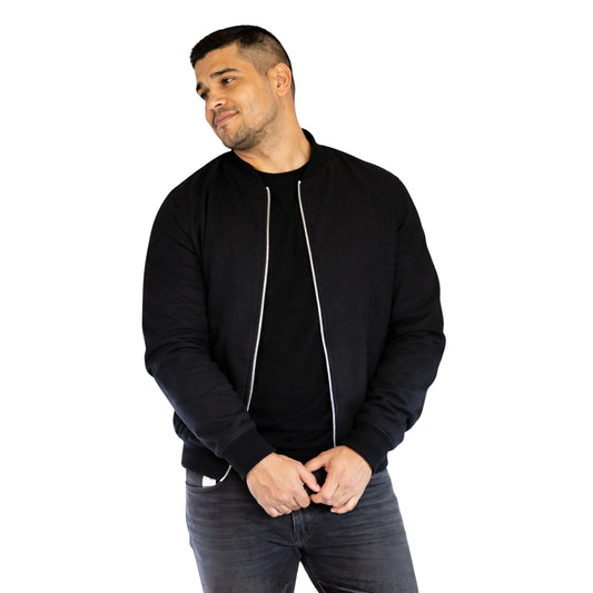 Man wearing a black bomber jacket on a white background