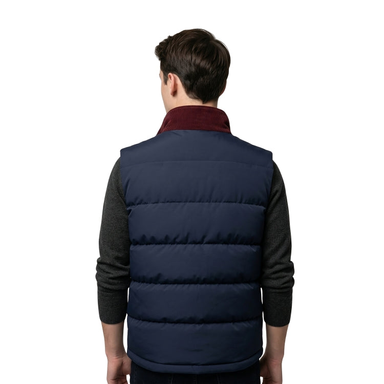 Person wearing a navy puffer vest over a dark shirt on a white background