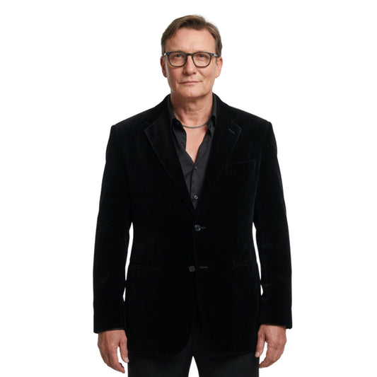 Man wearing a black velvet blazer on a white background