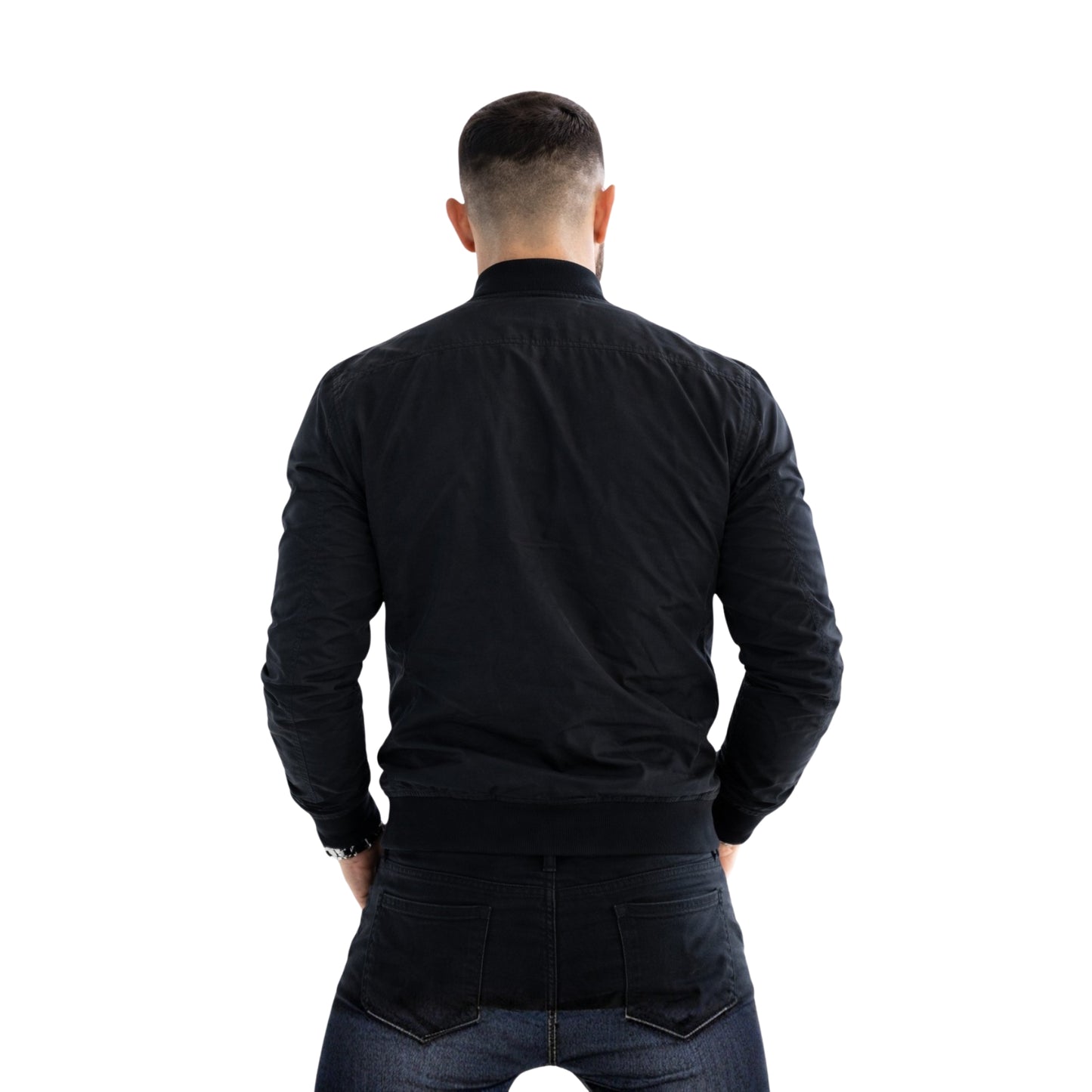 Man wearing a black jacket and jeans from behind on a white background