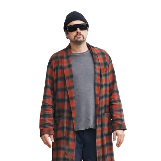 Man wearing a red and black plaid coat over a gray shirt on a white background