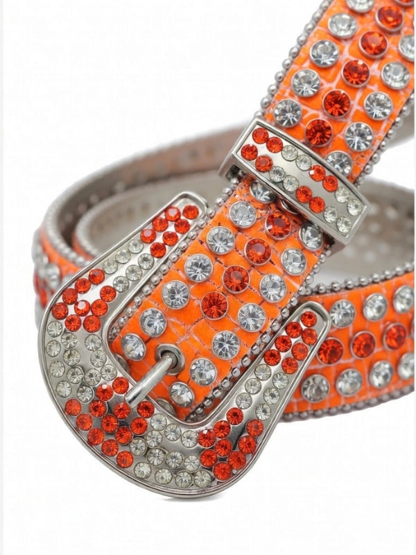 Orange belt with silver and red gemstones on a white background